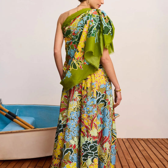Rear view of woman wearing a colourful cotton skirt with a scarf as a top