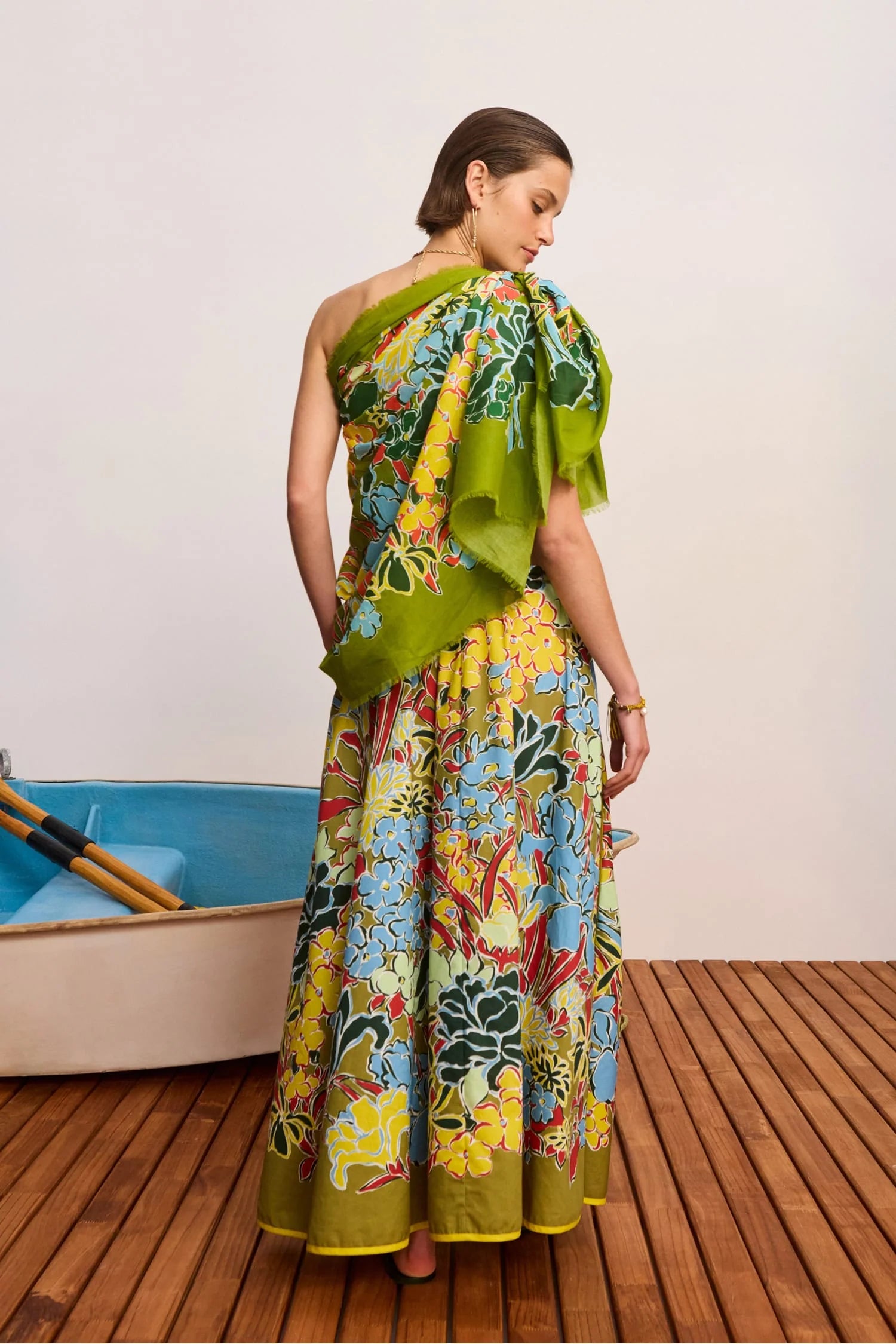Rear view of woman wearing a colourful cotton skirt with a scarf as a top