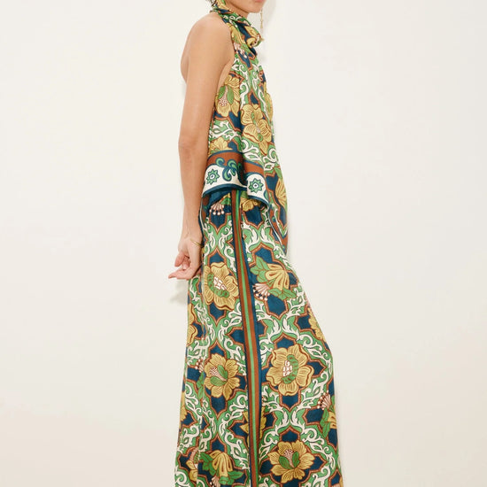 Side view of silk scarf style top worn with silk wide leg trousers