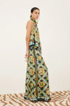 Side view of silk scarf style top worn with silk wide leg trousers