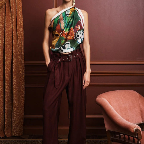 Colorful patchwork scarf with floral and abstract patterns by Alemais on a white background being worn as a top