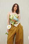 Square silk scarf worn as a top with trousers with a jungle print from Alemais