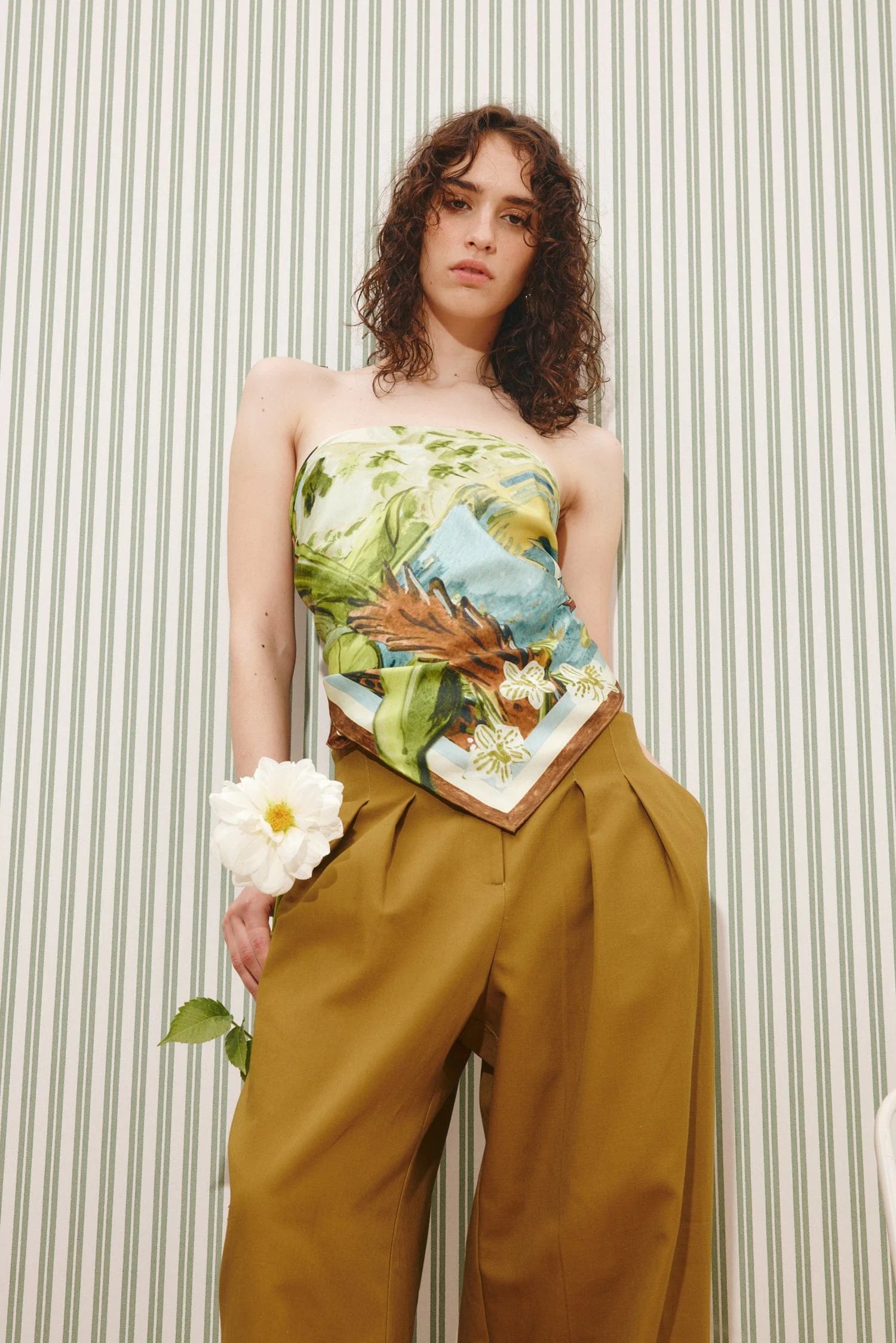 Square silk scarf worn as a top with trousers with a jungle print from Alemais