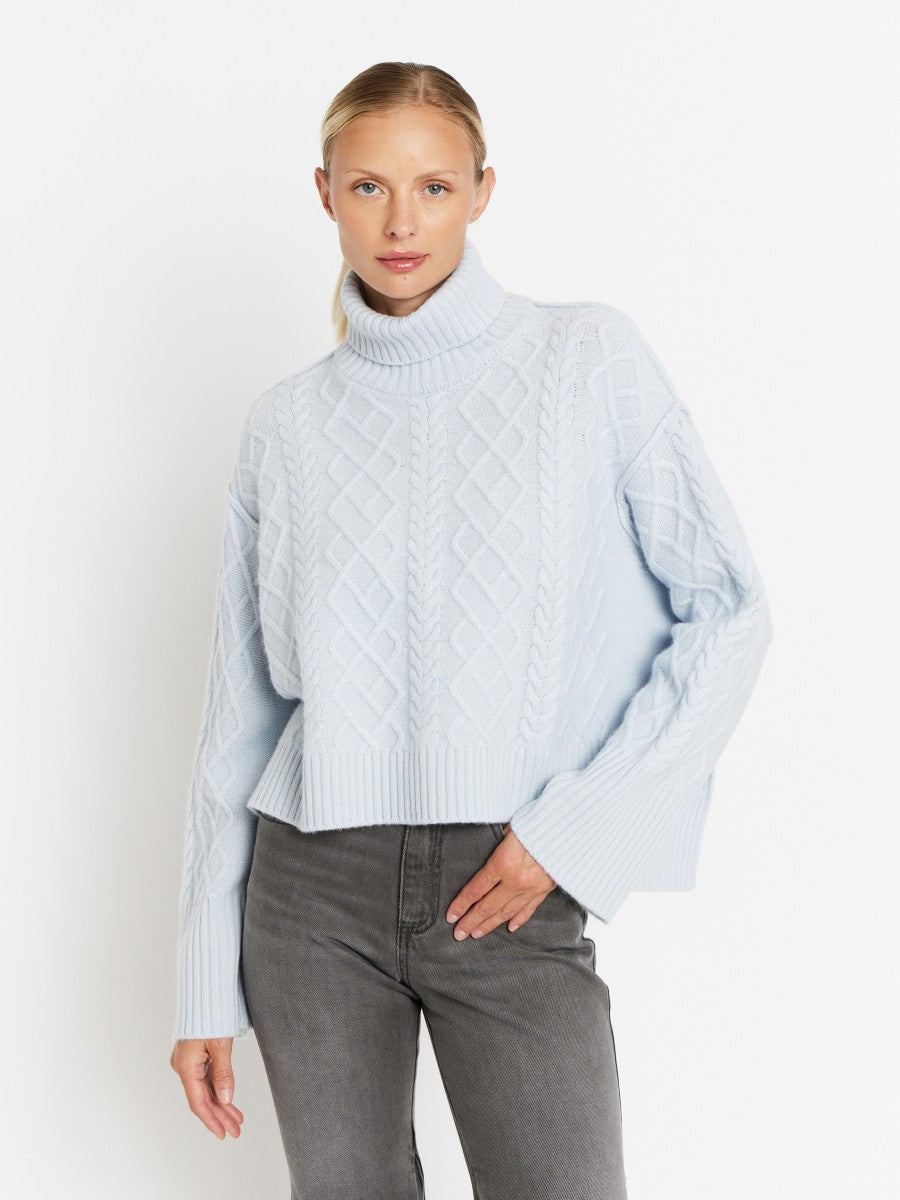 Turtleneck cable knit jumper with long wide sleeves and dropped hem