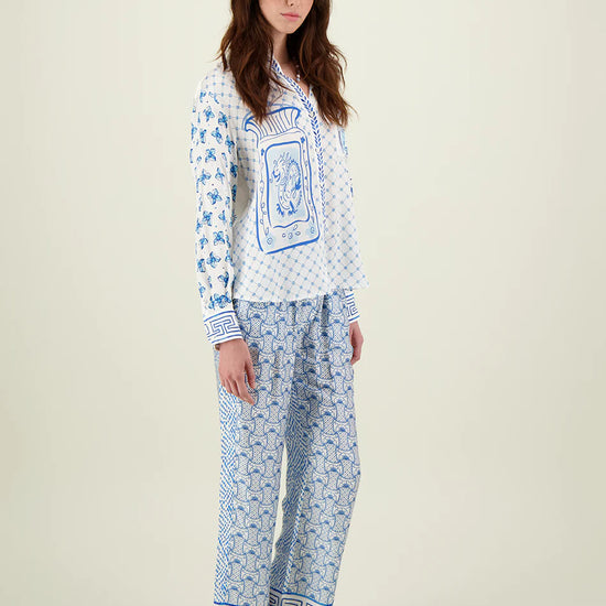 Blue and ivory patterned straight leg trousers with border hems and contrast fabric on the back