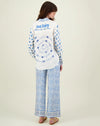 Blue and ivory patterned straight leg trousers with border hems and contrast fabric on the back