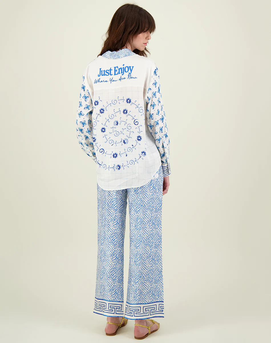 Blue and ivory patterned straight leg trousers with border hems and contrast fabric on the back