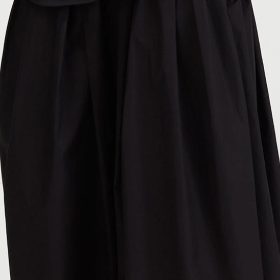 Black skirt with a draped neckline on a white background