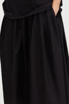 Black skirt with a draped neckline on a white background