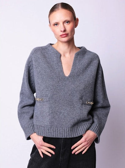 Grey v-neck jumper with 2 front pockets pockets and gold buckle detailing