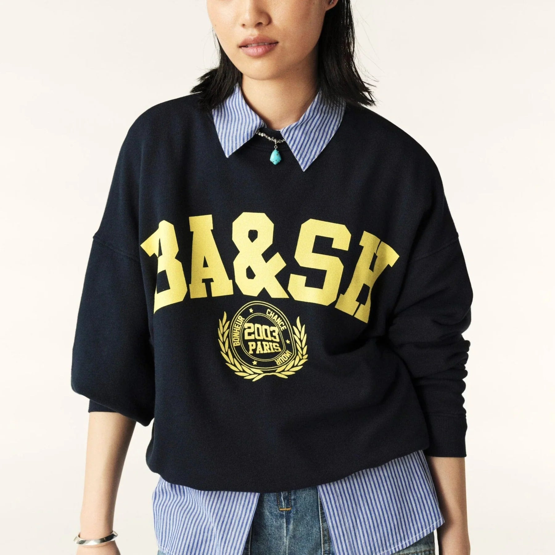 Model shot of navy sweatshirt with yellow ba&sh branding