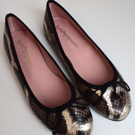 Mock snake leather ballet pumps with black bow on toe with gold shimmer detail