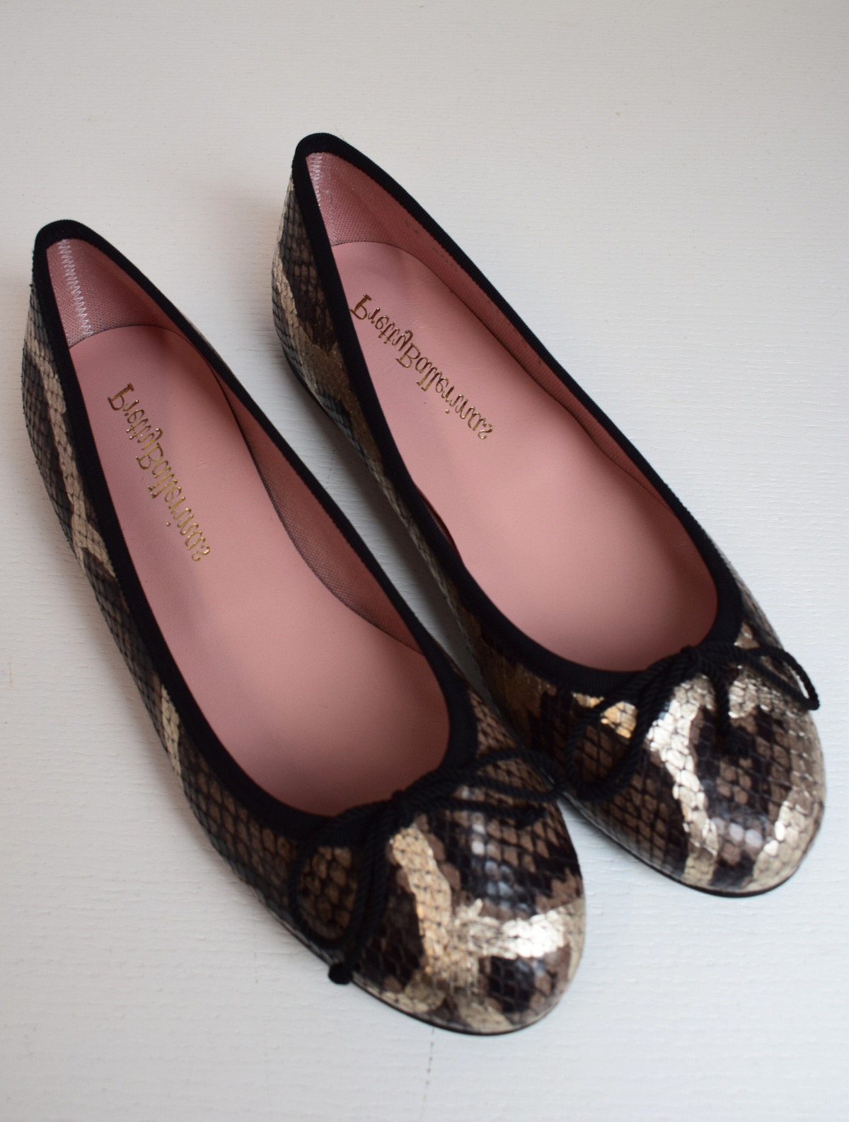 Mock snake leather ballet pumps with black bow on toe with gold shimmer detail