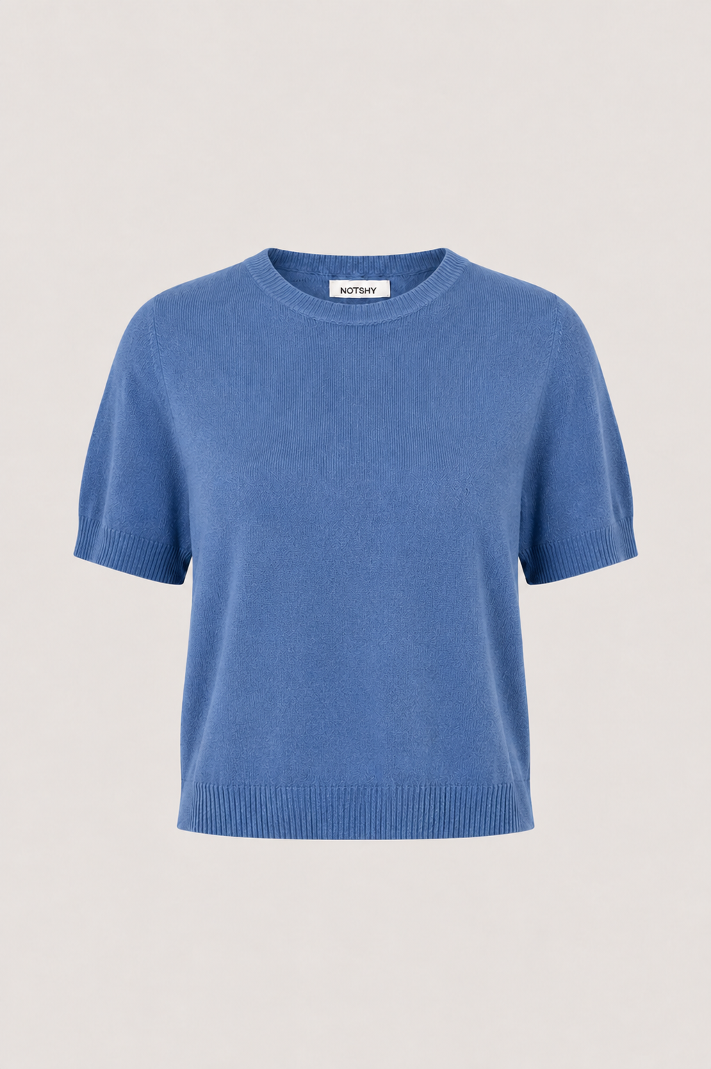 A short-sleeve crewneck knit sweater in a medium blue color, displayed on a neutral light beige background.
