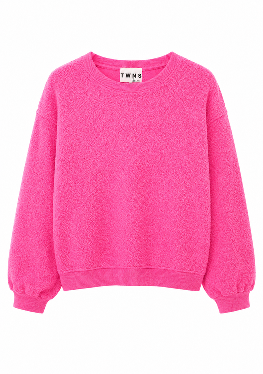 A bright pink crewneck sweatshirt with balloon sleeves, shown flat against a plain white background. The brand label inside the collar reads 'TWNS'.