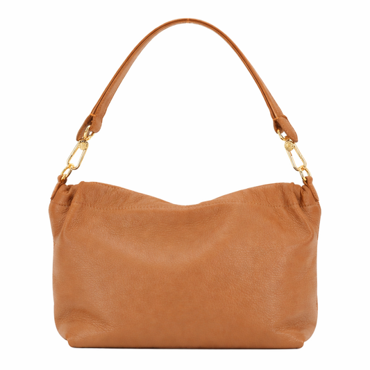 Tan leather handbag with gold hardware on a white background