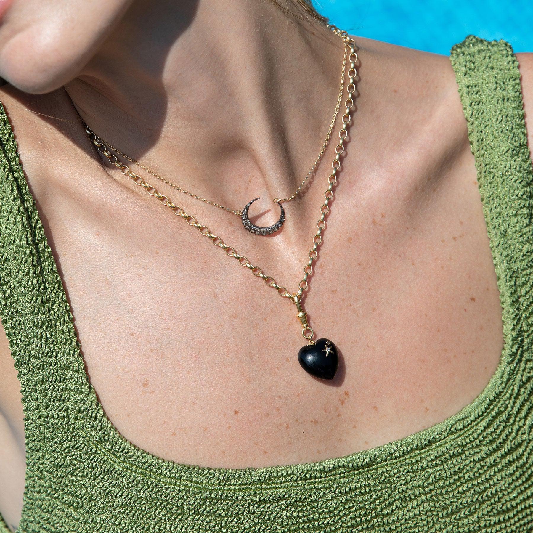 Black heart pendant with a diamond and star detail on a gold plated sterling sliver belcher chain