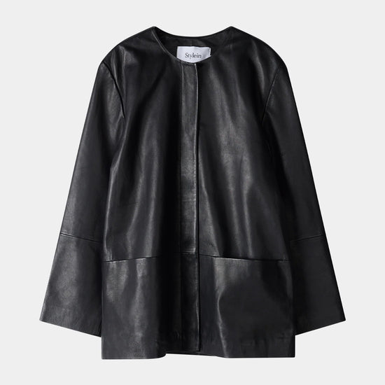 Black leather cape on a light gray background