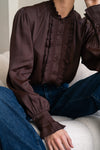Woman wearing brown shirt and jeans close up of shirt detail