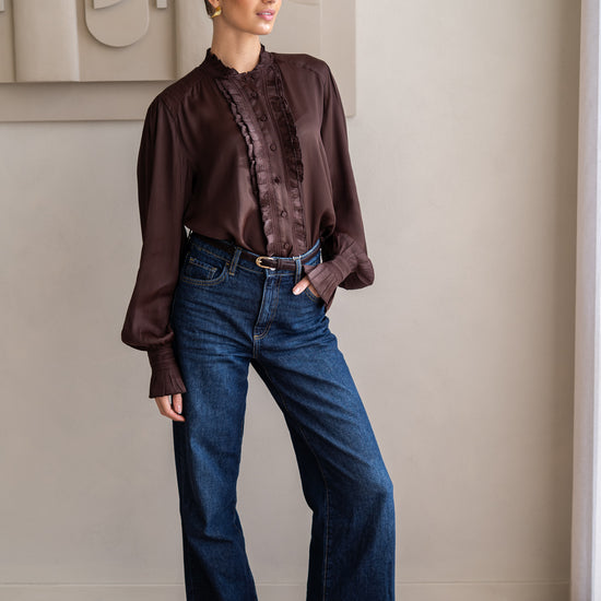 woman wearing brown blouse and boots with jeans 