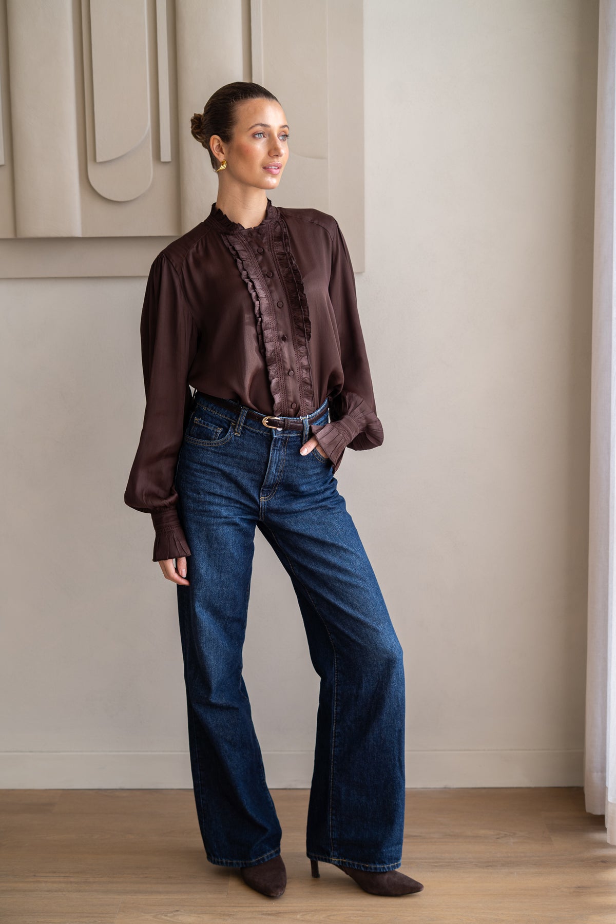 woman wearing brown blouse and boots with jeans 