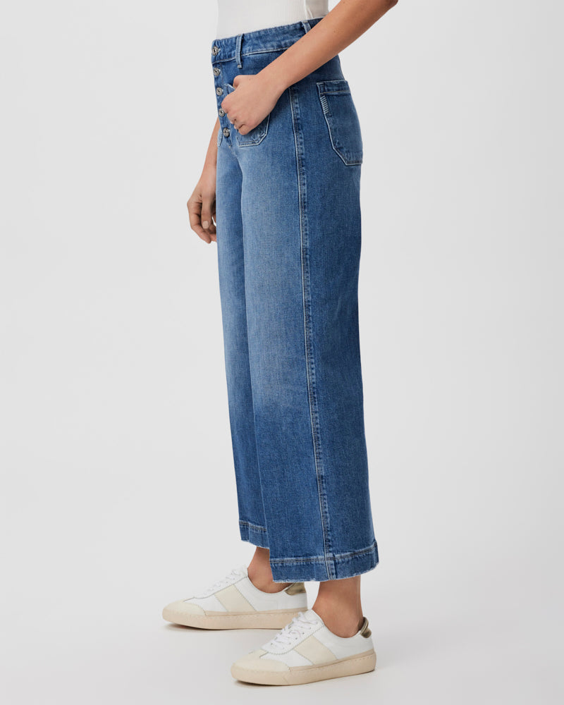Light wash cropped wide straight leg jeans with front patch pockets and silver button zip fly
