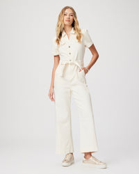 Cream short sleeved jumpsuit with straight leg, tie waist and silver button fastening