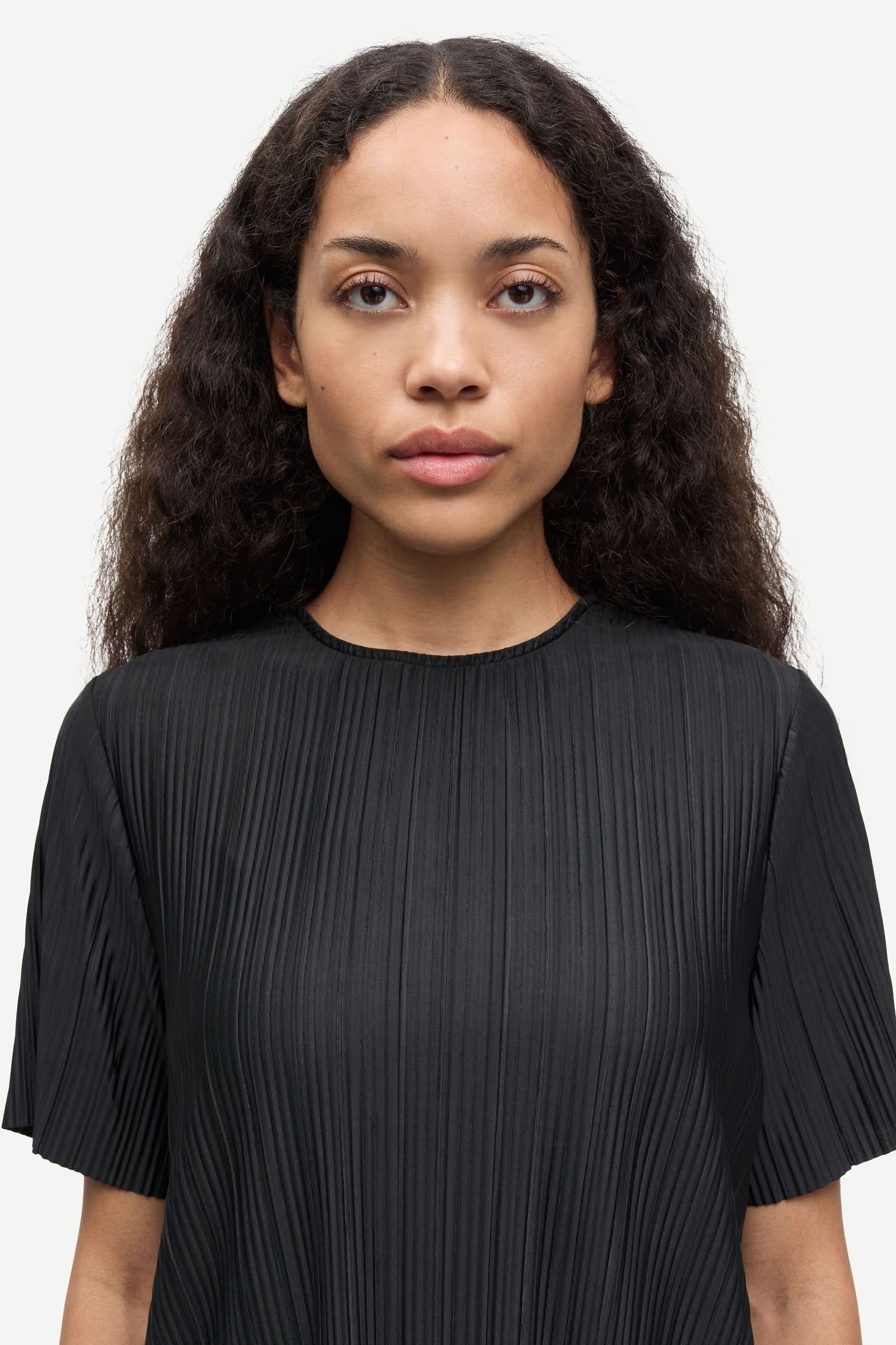 short sleeve pleated black top with round neck from samsoe samsoe model shot close up