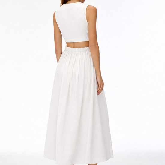 Woman wearing a white sleeveless top and long skirt on a white background