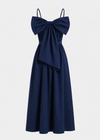 Navy blue dress with a large bow detail on a light gray background