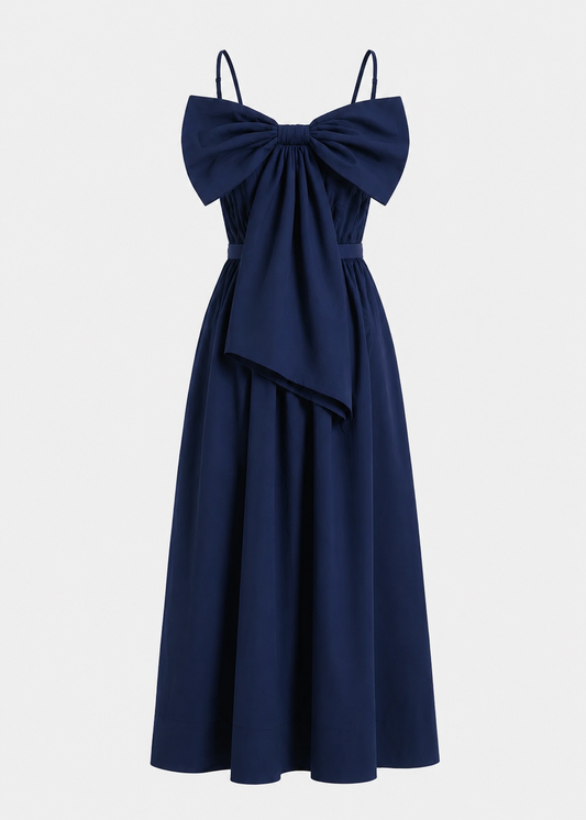 Navy blue dress with a large bow detail on a light gray background