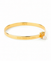 Gold Bangle with engraving on plain background