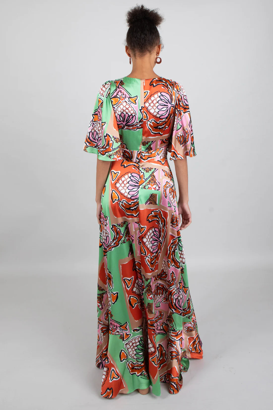 Green brown pink and black silk faux wrap dress with elbow length sleeves and a cascading shaped maxi hemline