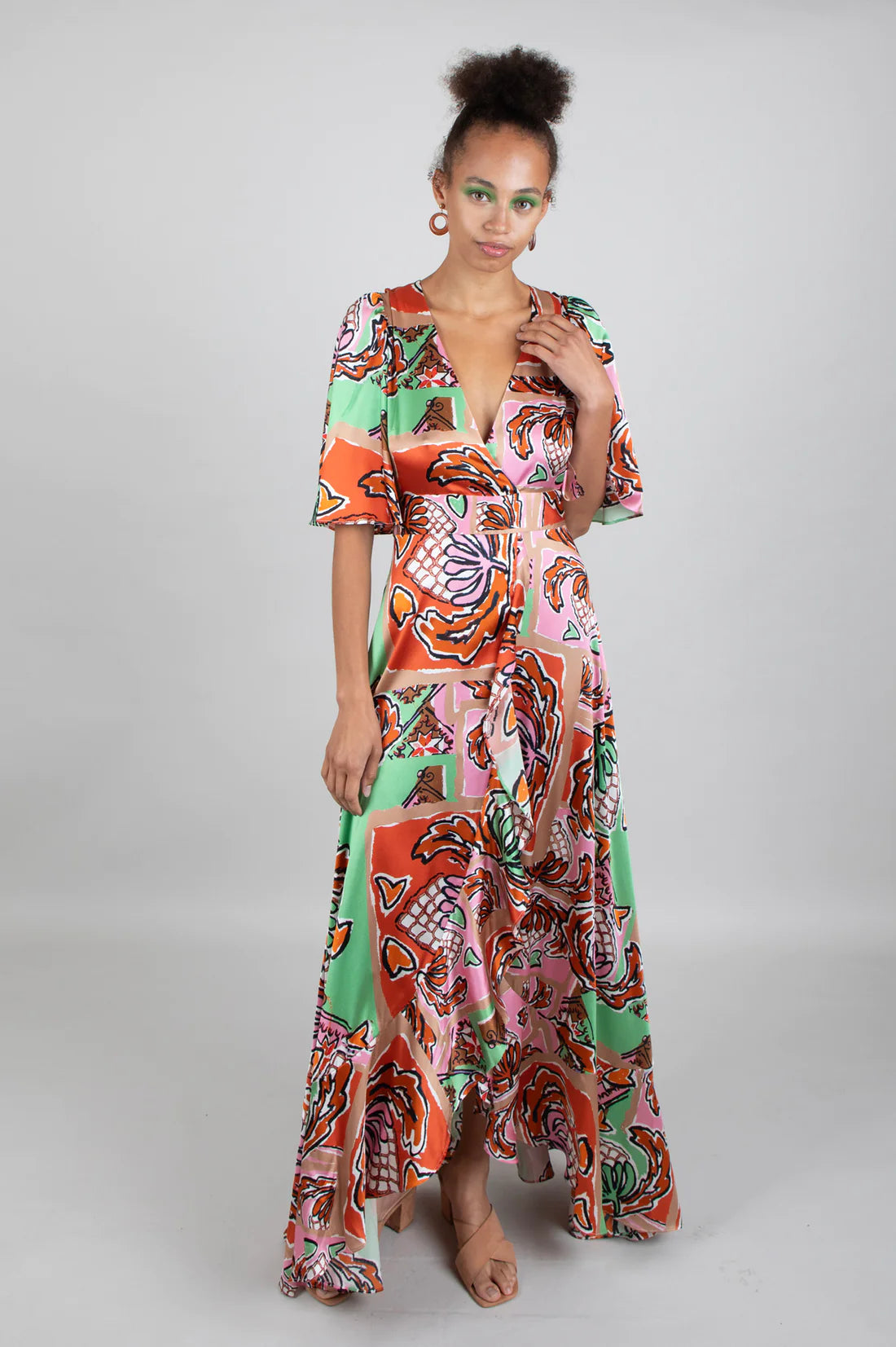 Green brown pink and black silk faux wrap dress with elbow length sleeves and a cascading shaped maxi hemline
