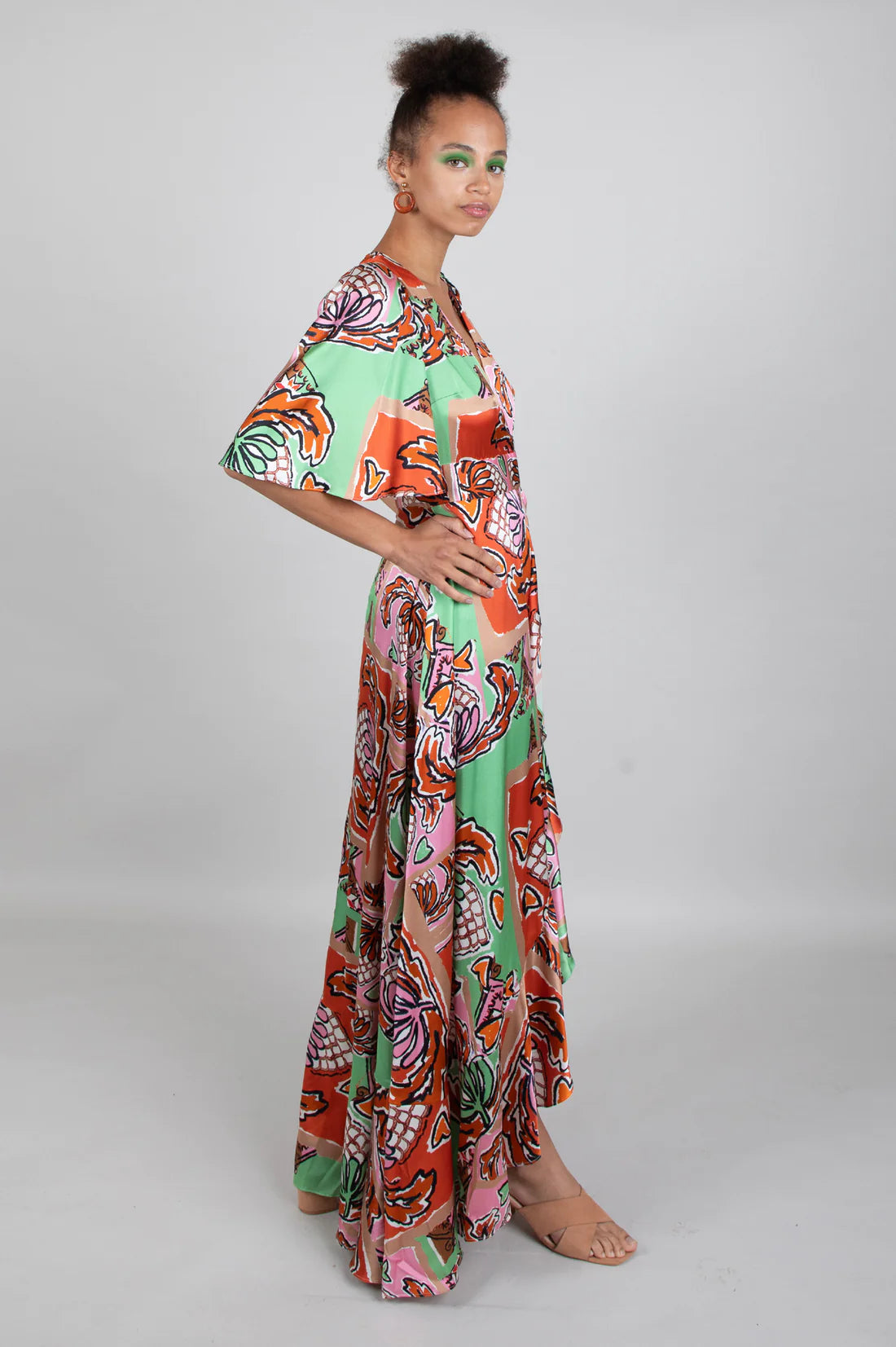 Green brown pink and black silk faux wrap dress with elbow length sleeves and a cascading shaped maxi hemline