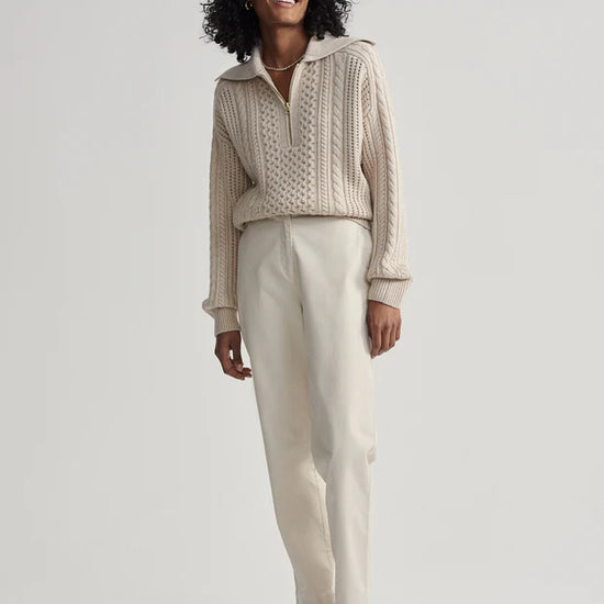 beige cable knit sweater with oversized collar and quarter zip model shot