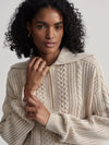 beige cable knit sweater with oversized collar and quarter zip close up