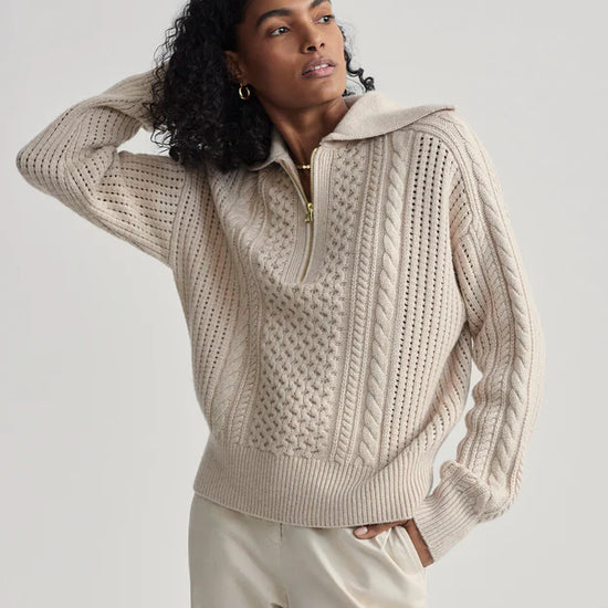 beige cable knit sweater with oversized collar and quarter zip model shot