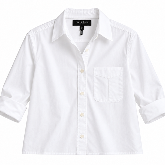 A white long-sleeve button-down shirt with a single chest pocket, laid flat against a white background. The brand label 'the & me' is visible inside the collar.