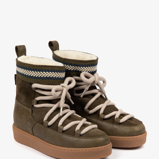 Pair of khaki boots with white laces on a white background