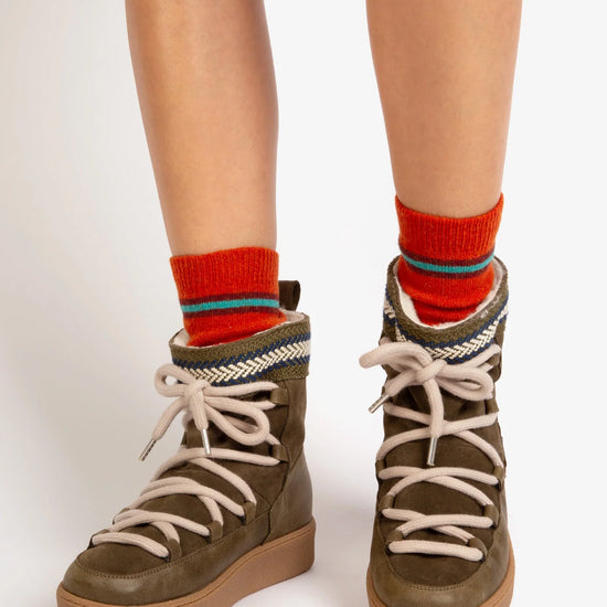 pweson wearing khaki green leather and suede boots with faux fur lining