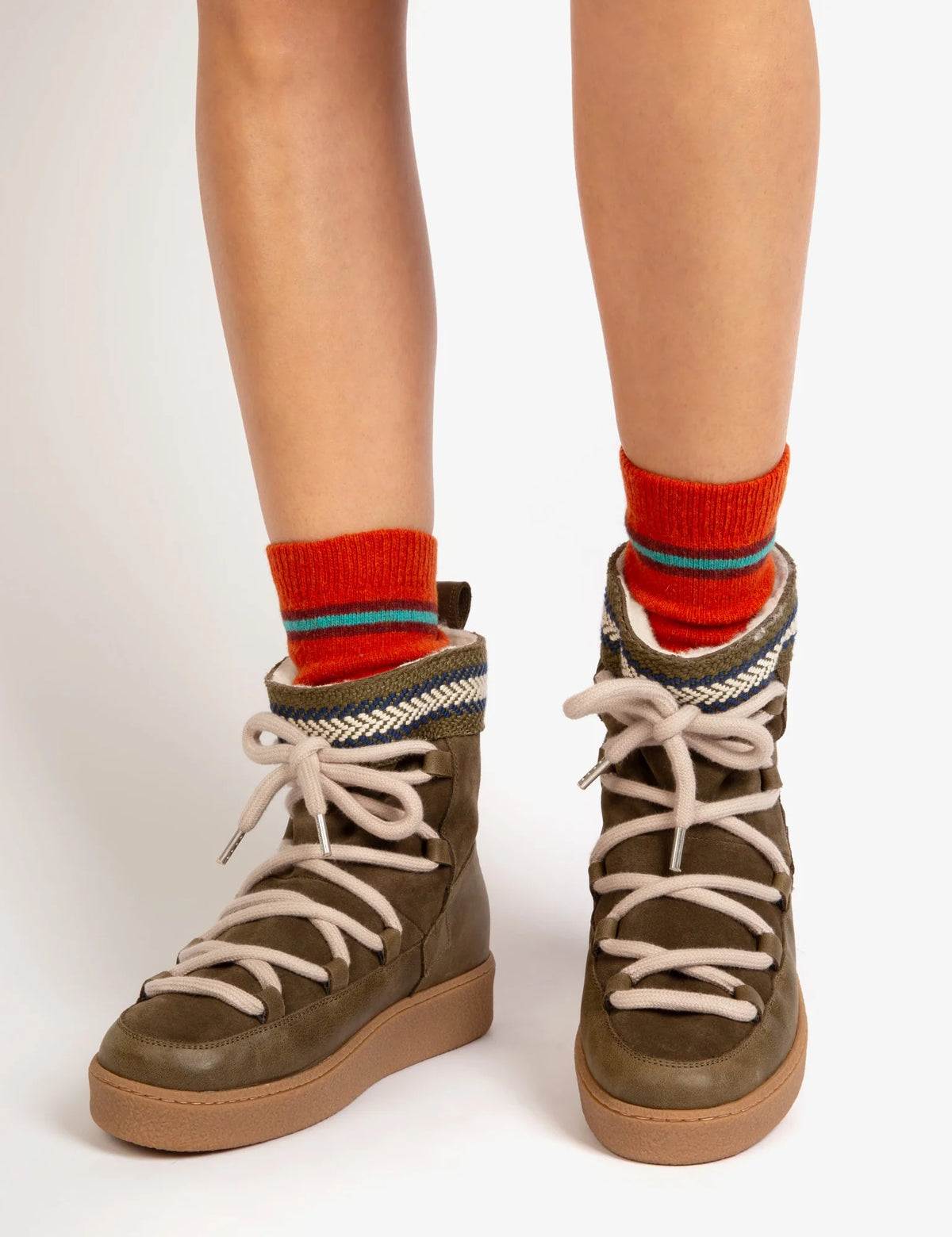 pweson wearing khaki green leather and suede boots with faux fur lining
