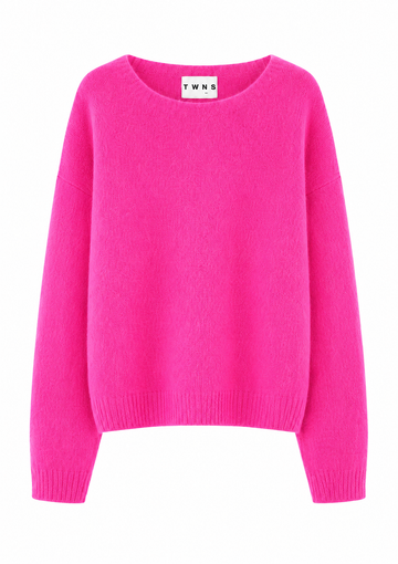 A bright pink crewneck sweater with long sleeves and ribbed cuffs and hem, shown against a plain white background. The inside collar label shows the brand name 'TWNS'.