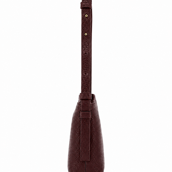 A dark brown textured leather shoulder bag shown from the back, featuring a matching leather strap with gold-tone rivets and a small embossed logo, set against a plain white background.