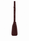 A dark brown textured leather shoulder bag shown from the back, featuring a matching leather strap with gold-tone rivets and a small embossed logo, set against a plain white background.