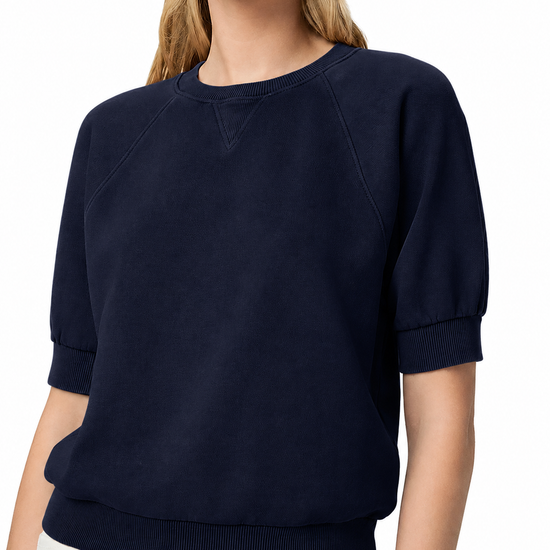 model wearing a navy blue short sleeve sweatshirt on a plain white background 