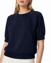 model wearing a navy blue short sleeve sweatshirt on a plain white background 