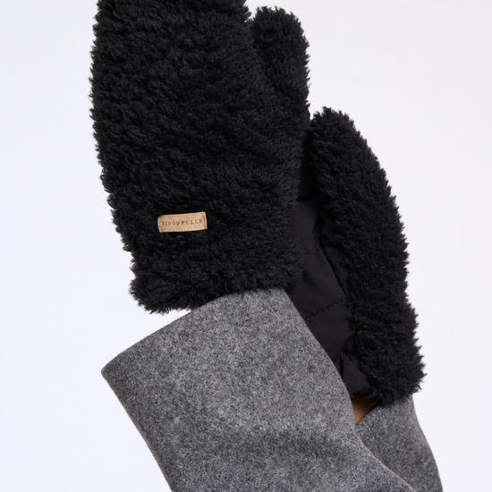 Black fleece-lined mittens worn on hands, shown against a plain white background. The sleeves are gray, and a small tan brand tag is visible on one mitten.