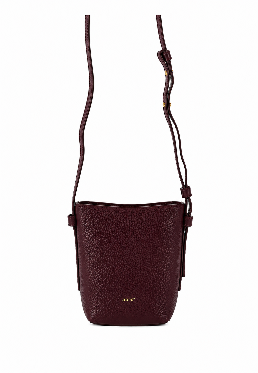 A dark burgundy pebbled leather crossbody bag with a thin matching leather strap and a small gold logo on the front, shown against a plain white background.