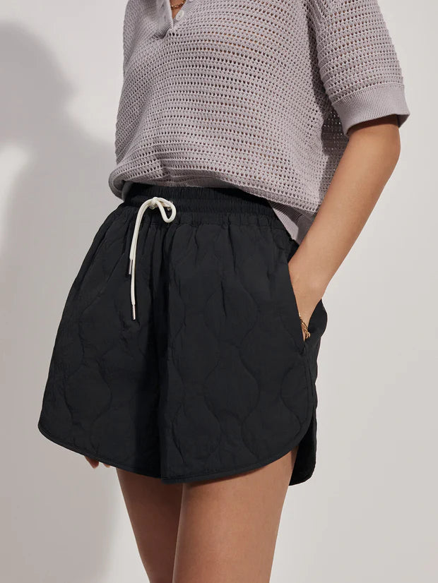 Quilted black shorts with white tie waist